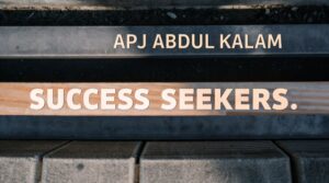 Inspirational sign with the words “APJ Abdul Kalam” and “SUCCESS SEEKERS.” engraved on wooden and metal planks.