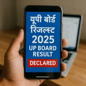 Realistic photo of a person holding a smartphone showing “UP Board Result 2025 Declared” in Hindi and English on the screen, with a laptop blurred in the background.